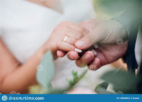Groom Holds The Bride By The Hand Wedding Rings Close Up Stock Photo