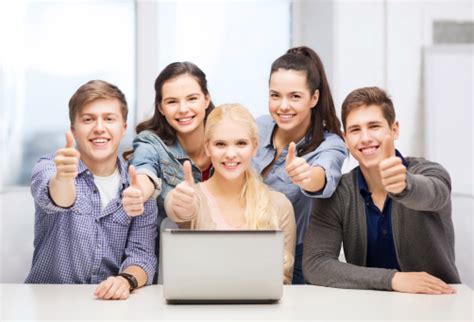 Smiling Students With Laptop Showing Thumbs Up Stock Photo Download