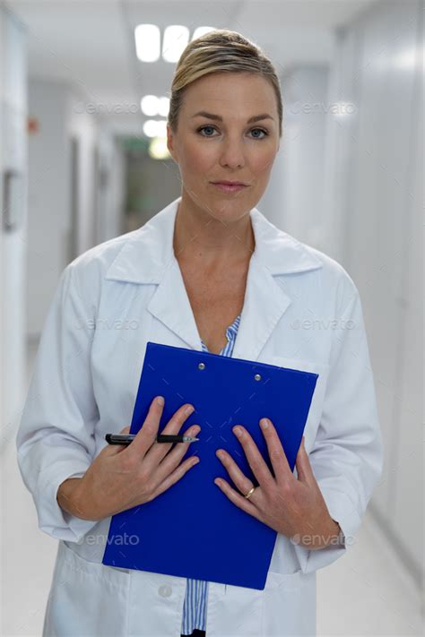 Portrait Of Caucasian Female Doctor Standing In Hospital Corridor