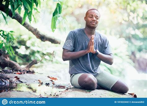 African Man Spiritual Peaceful Praying And Wishing In Green Nature