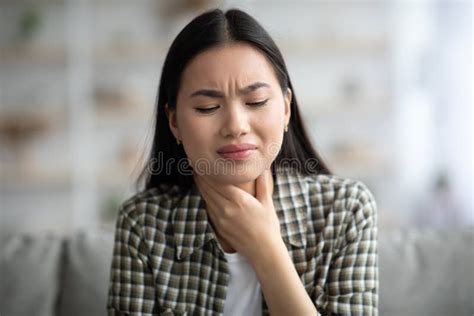Sad Asian Woman Rubbing Her Throat Home Interior Stock Image Image