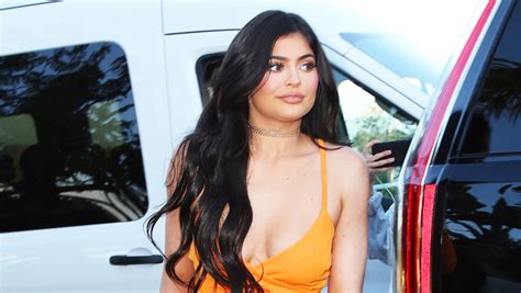 Kylie Jenner Rocks Orange Swimsuit During Photo Shoot — Watch