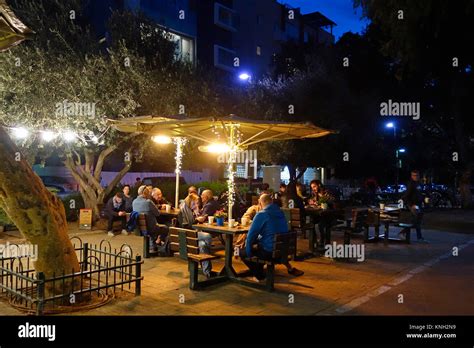 People Sitting And Drinking Coffee In Ben Gurion Boulevard In Tel Aviv