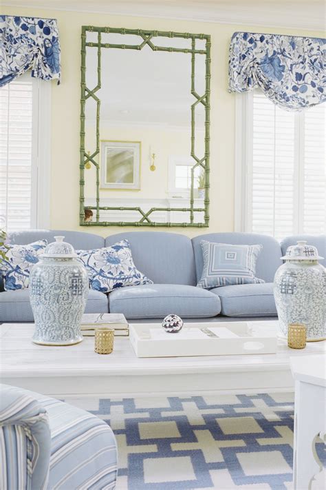 An Image Of A Living Room With Blue And White Decor On The Couches