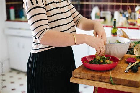 Tossing Salad In The Kitchen By Cherish Bryck Stocksy United