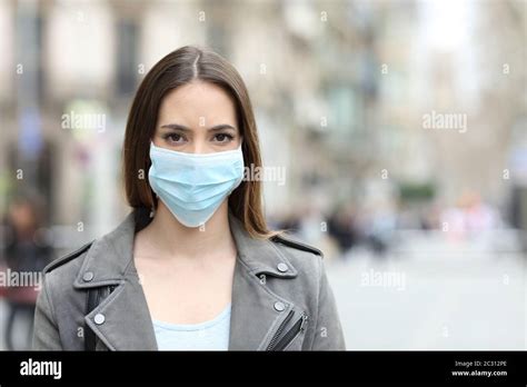 Front View Portrait Of Serious Woman With Protective Mask Avoiding