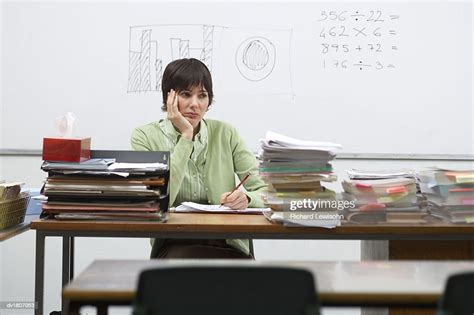 Miserable Female Teacher Sitting Behind A Desk Photo Getty Images