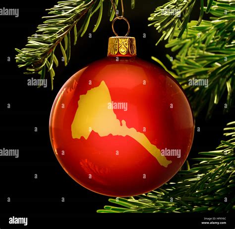 A Red Bauble With The Golden Shape Of Eritrea Hanging On A Christmas