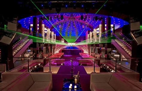 The Inside Of A Large Building With Lights On And Purple Carpeted