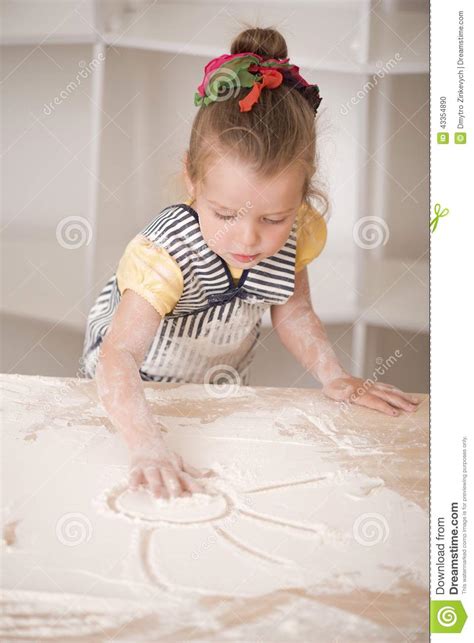 Cute Little Girl Working With Rolling Pin Stock Photo