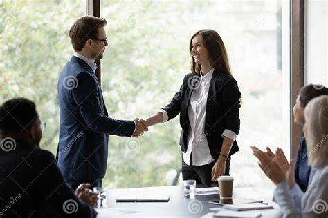 Male Boss Handshake Female Employee At Office Meeting Stock Photo