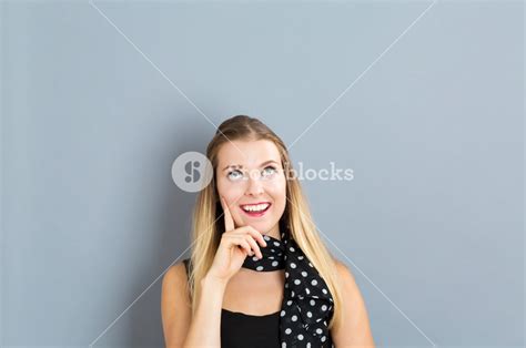 Young Woman In A Thoughtful Pose On A Gray Background Royalty Free