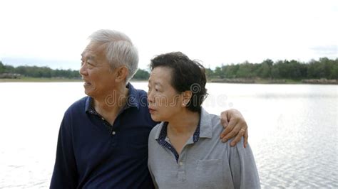 Asian Senior Couple Happy Hugging Together Lake Background Stock Image