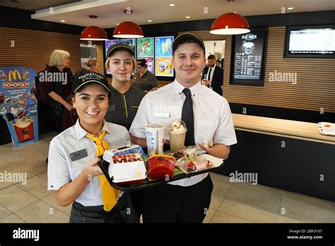 Portrait of three McDonalds restaurant staff in uniform in the the UK