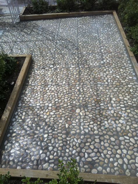 A concrete paver walkway with mexican pebble joints leads from the main house to the backyard art studio. www.pavingcanberra.com Paving Product: 400 x 400 River ...