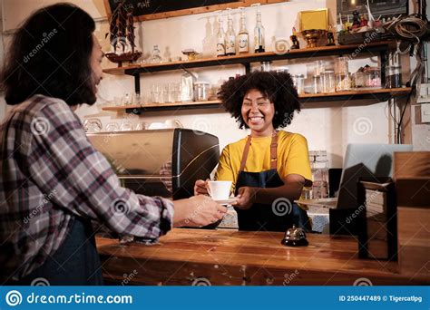 Two Baristas Partners Work And Cheerful Smile At The Counter Bar Of Coffee Shop Stock Image