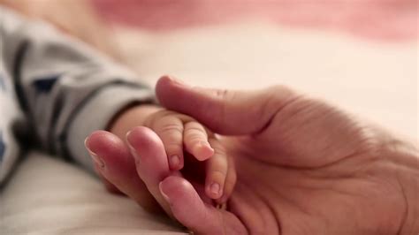 Mother And Her Newborn Baby Parent Holding Newborns Hand Happy Mother