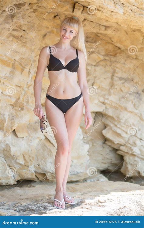 girl on wild rocky seashore stock image image of attractive hair 209916975