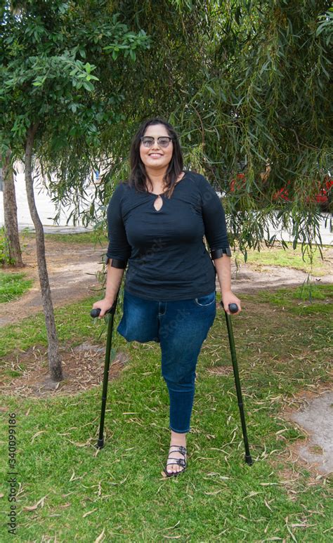 Young Beautiful Amputee Woman Walking With Crutches Stock Foto Adobe Stock