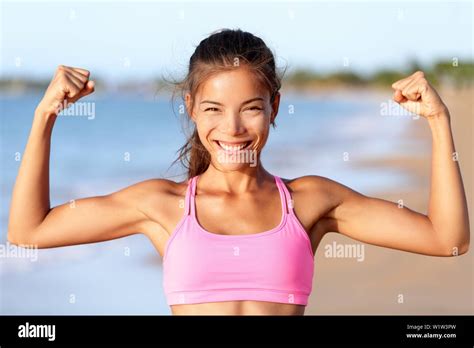 Happy Sporty Fitness Woman Flexing Muscles On Beach Smiling Young Is