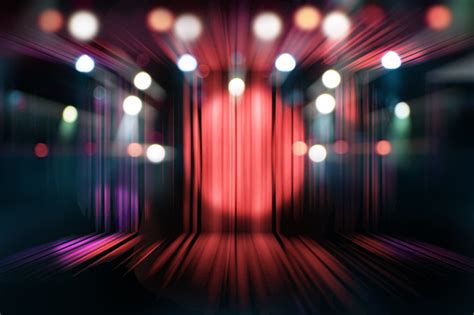 Blurred Theater Stage With Red Curtains And Spotlights