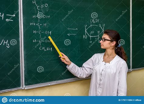Female Portrait Chemistry Teacher Standing Near Class Board Pointing