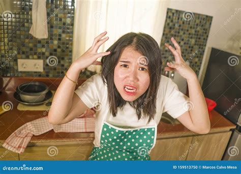 Young Tired And Stressed Asian Chinese Woman In Cook Apron Working In