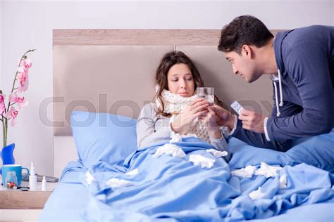 Wife Caring For Sick Husband At Home In Bed Stock Image Colourbox