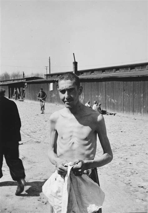 An Emaciated Russian Survivor Stares Into The Camera After His Liberation At Buchenwald