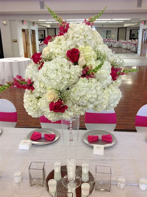 this overwhelming masterpiece features 30 white hydrageas offset with hot pink and ivory roses