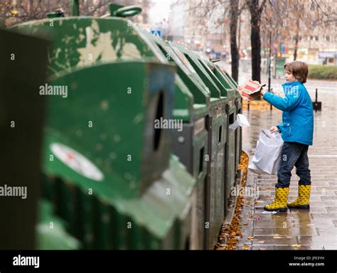 Boy Putting Waste Into Recycling Bin Stock Photo Alamy