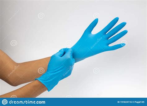 Female Hand Wears A Protective Glove For Cleaning Or Tidying Woman`s
