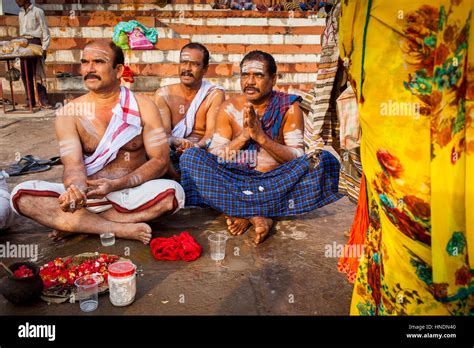 pilgrims making a ritual offering and praying ghats in ganges river varanasi uttar pradesh