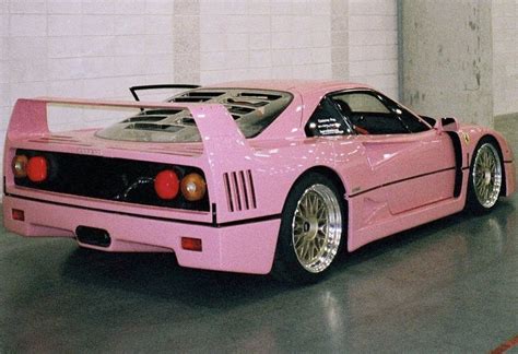 A Pink Sports Car Parked In A Garage