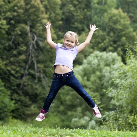 Happy Little Girl Jumping In Summer Day Photo Background And Picture