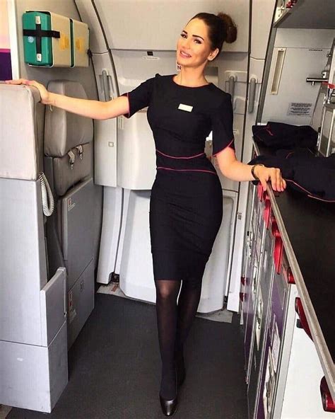 A Woman Is Standing In The Aisle Of An Airplane