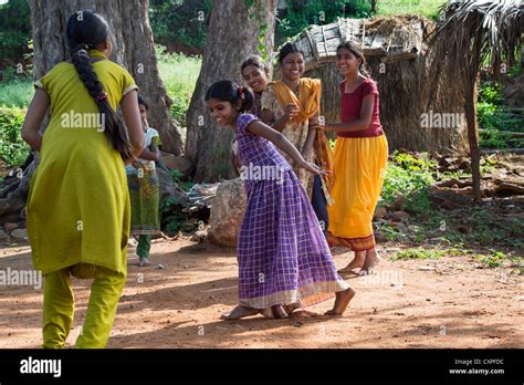 Indian Girls Laughing Whilst Playing Games In A Rural Indian Village