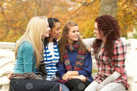 Group Of Four Teenage Girls Sitting And Chatting Stock Photo Image Of