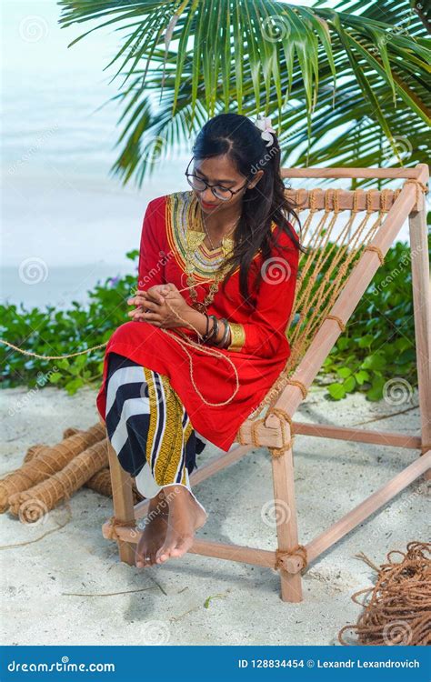 Beautiful Maldivian Woman In National Dress Producing Ropes Editorial