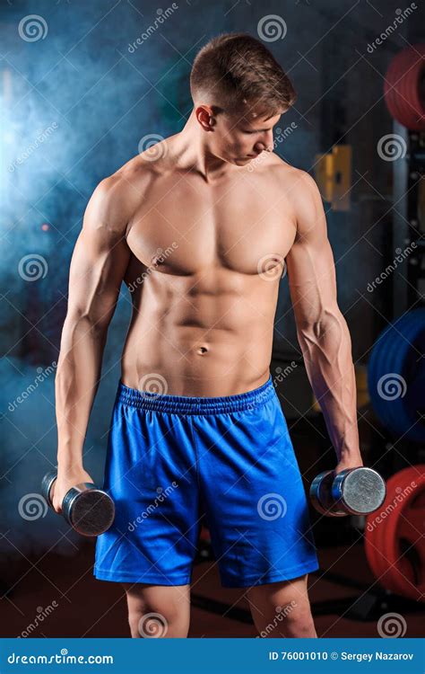 Man Doing Heavy Weight Exercise With Dumbbells In Gym Stock Photo