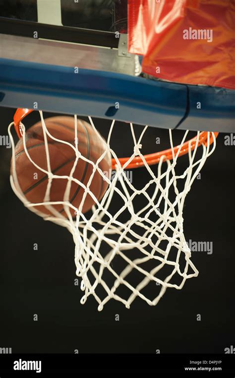 Basketball Going Through Hoop Stock Photo Alamy
