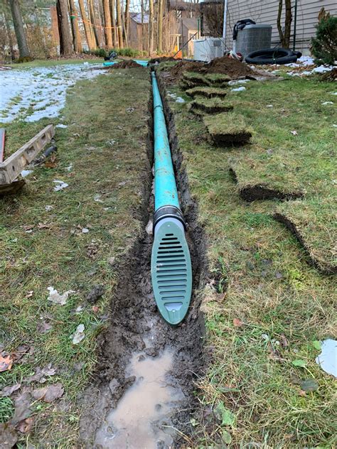 French Drain System Piped To A Mitered Surface Drain Installation