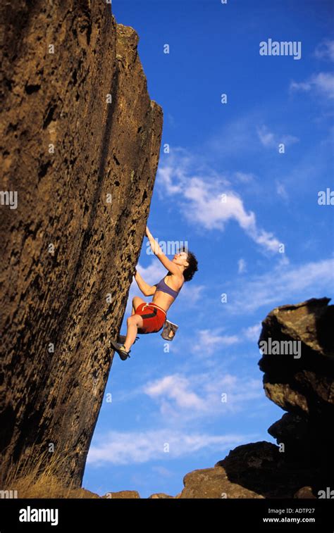 Female Rock Climber Climbing Steep Boulder Stock Photo Alamy