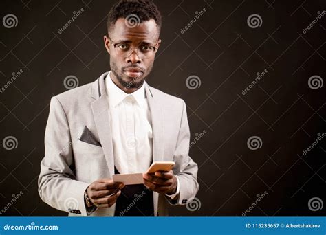 Photo Of Black Man In Fashionable Outfit With Calling Card And Cell