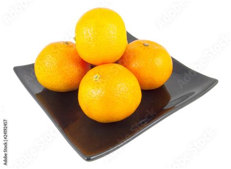 Five Oranges On Black Plate Isolated On White Stock Photo And Royalty