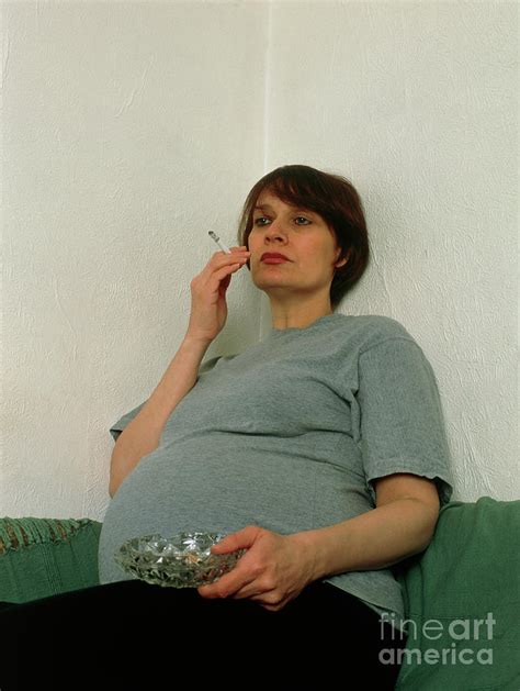 Pregnant Woman Smoking A Cigarette Indoors Photograph By Faye Norman