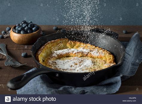 Homemade Dutch Baby Pancake With Blueberries And Powdered Sugar Stock