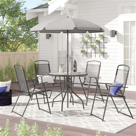 Sunbrella fabric cushions are sold separately. Tollette Round 4 - Person 31.25 Long Dining Set with ...
