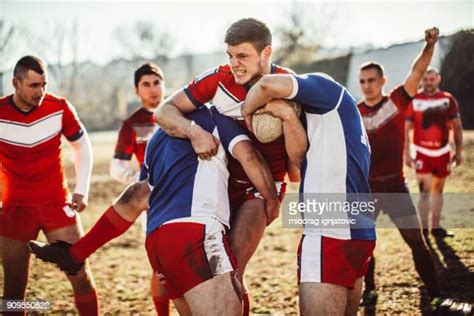 Rugby Players Tackling Each Other In Mud Photos And Premium High Res