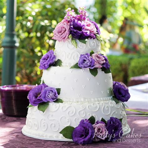 Photo Of A Wedding Cake White Purple Flowers Round Patty